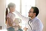 Medicaid doctor with young girl patient